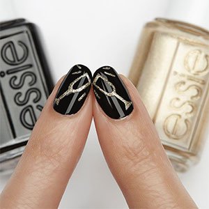 ¿Te ha encantado esta idea de uñas navideñas elegantes? Pues cálcala con el negro Licorice de essie y el dorado Gadget Free. ¡El dibujo practícalo antes!