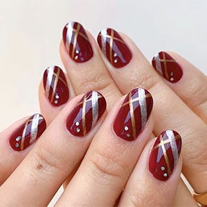 Necesitas los esmaltes Breaking the bold, Penny Talk y Gadget Free de essie para poner la nota de color. Pero a estas uñas burdeos decoradas aún les falta algo, ¿no crees? ¡Una pegatinas brillantes!