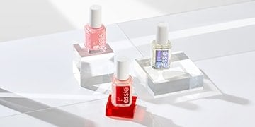 3 bottles of essie nail treatments, each on transparent stands in front of a white background.